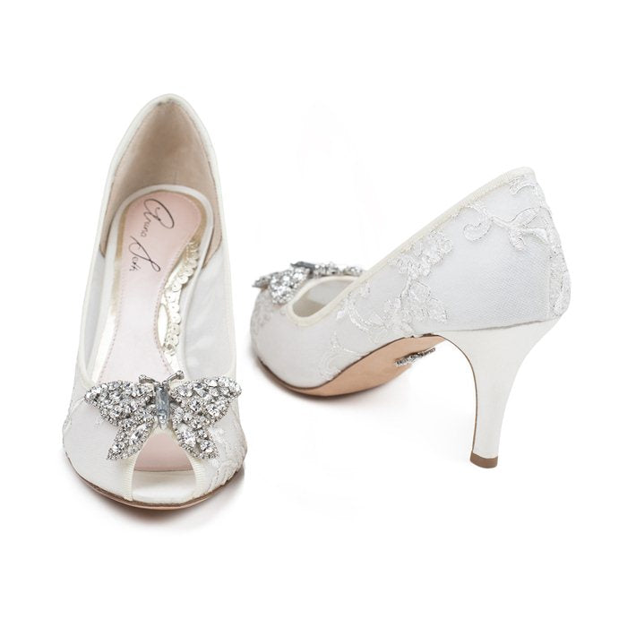 A pair of ivory lace open-toe platform heels with a butterfly embellishment and a 70mm stiletto heel.