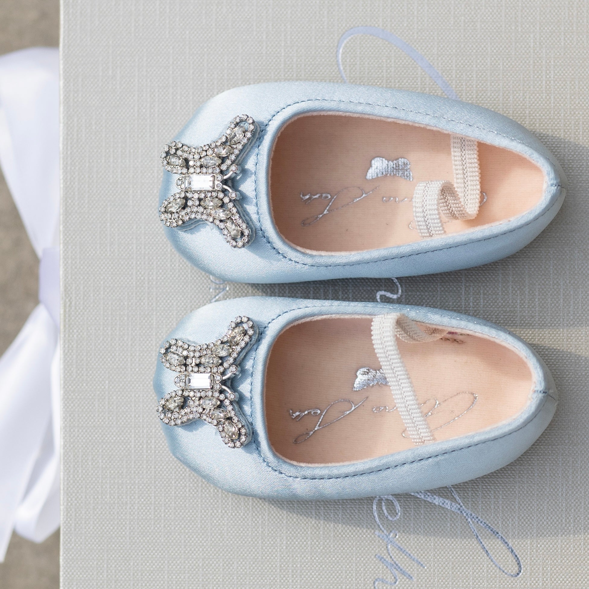 Elegant blue pre-walker baby shoes for weddings, crafted for flower girls with soft satin and luxurious detailing.