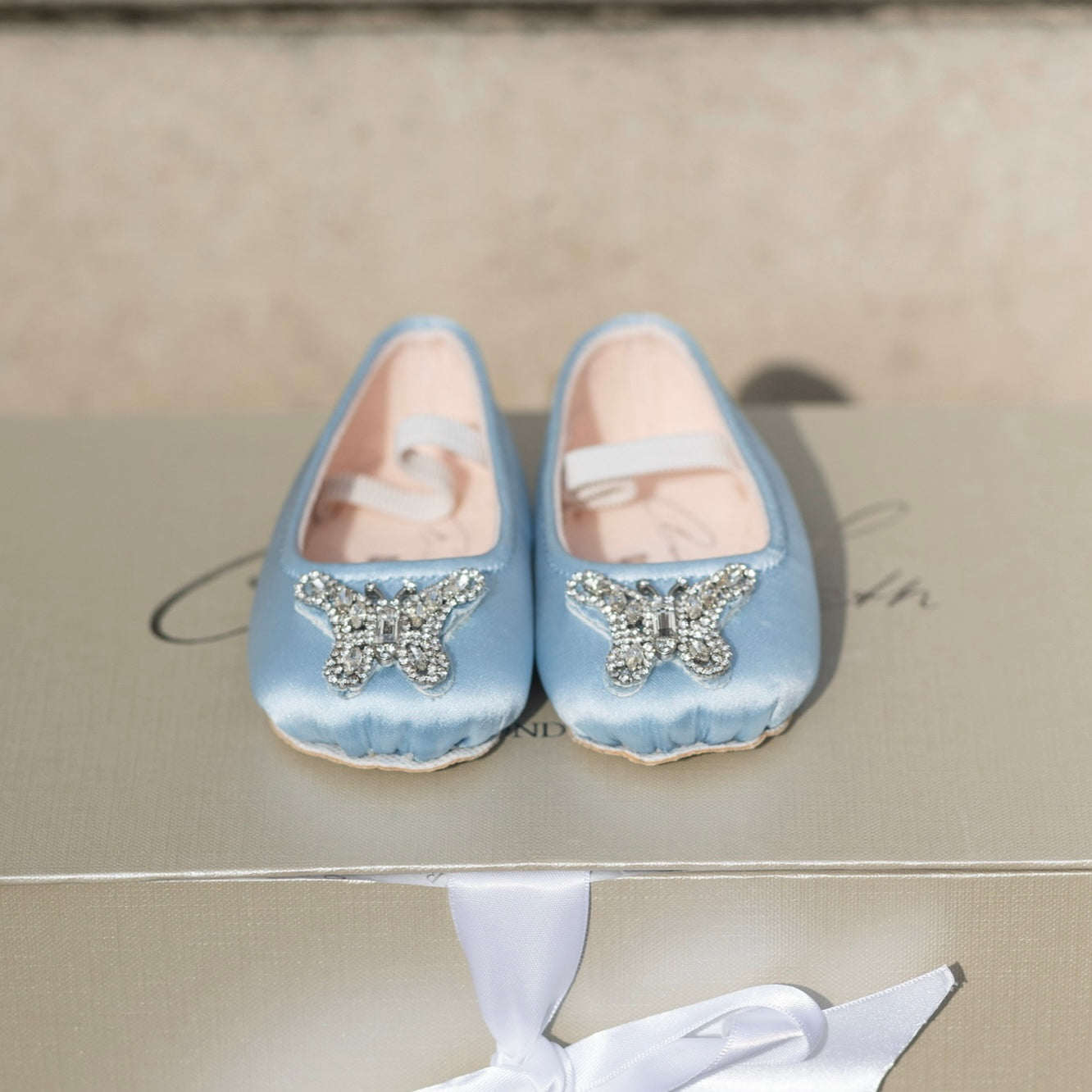 Elegant blue pre-walker baby girl shoes designed for flower girls, featuring soft satin and delicate lace for weddings and special occasions.