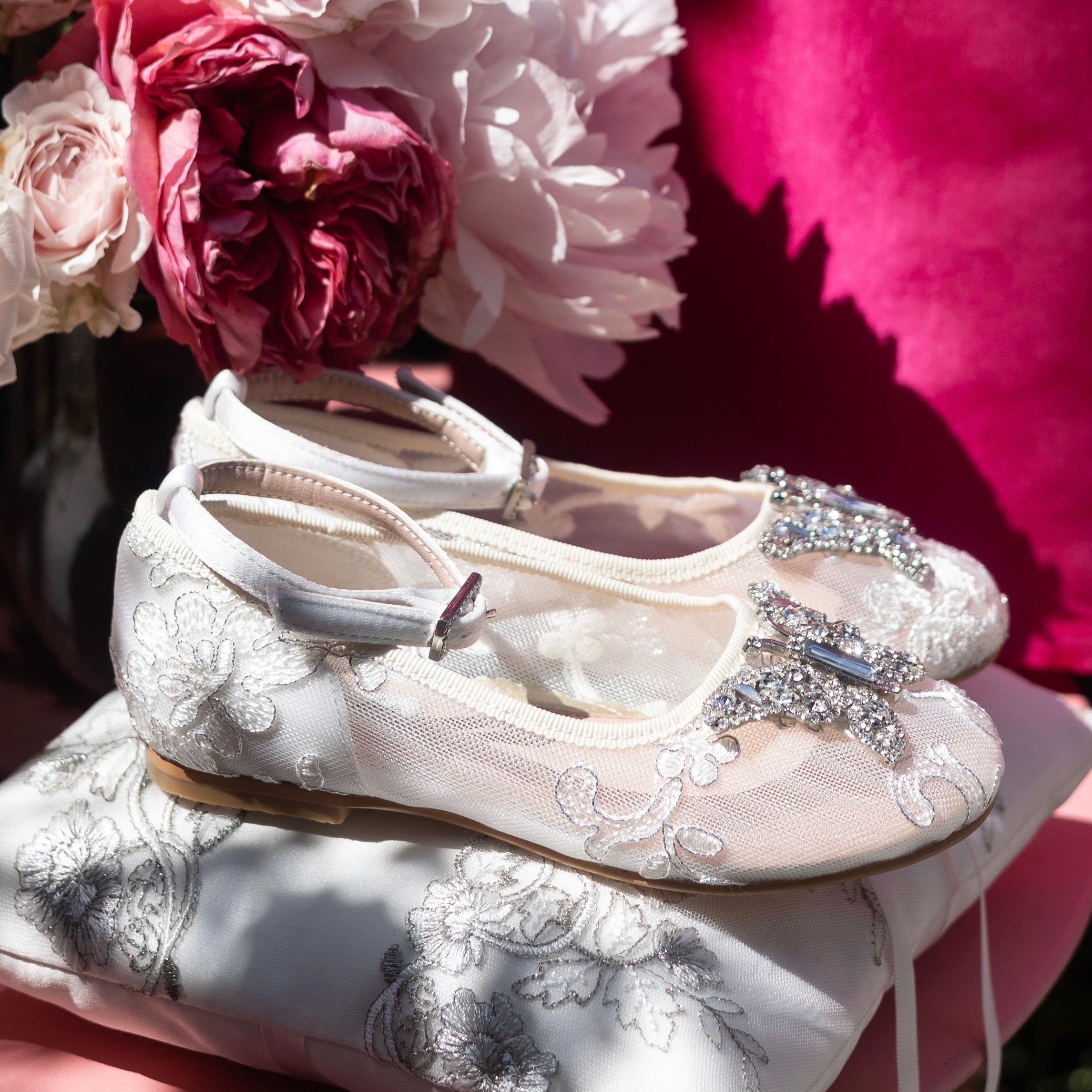 Designer ivory lace flower girl shoes perfect for bridal ceremonies, featuring intricate lace overlay and elegant satin finish.