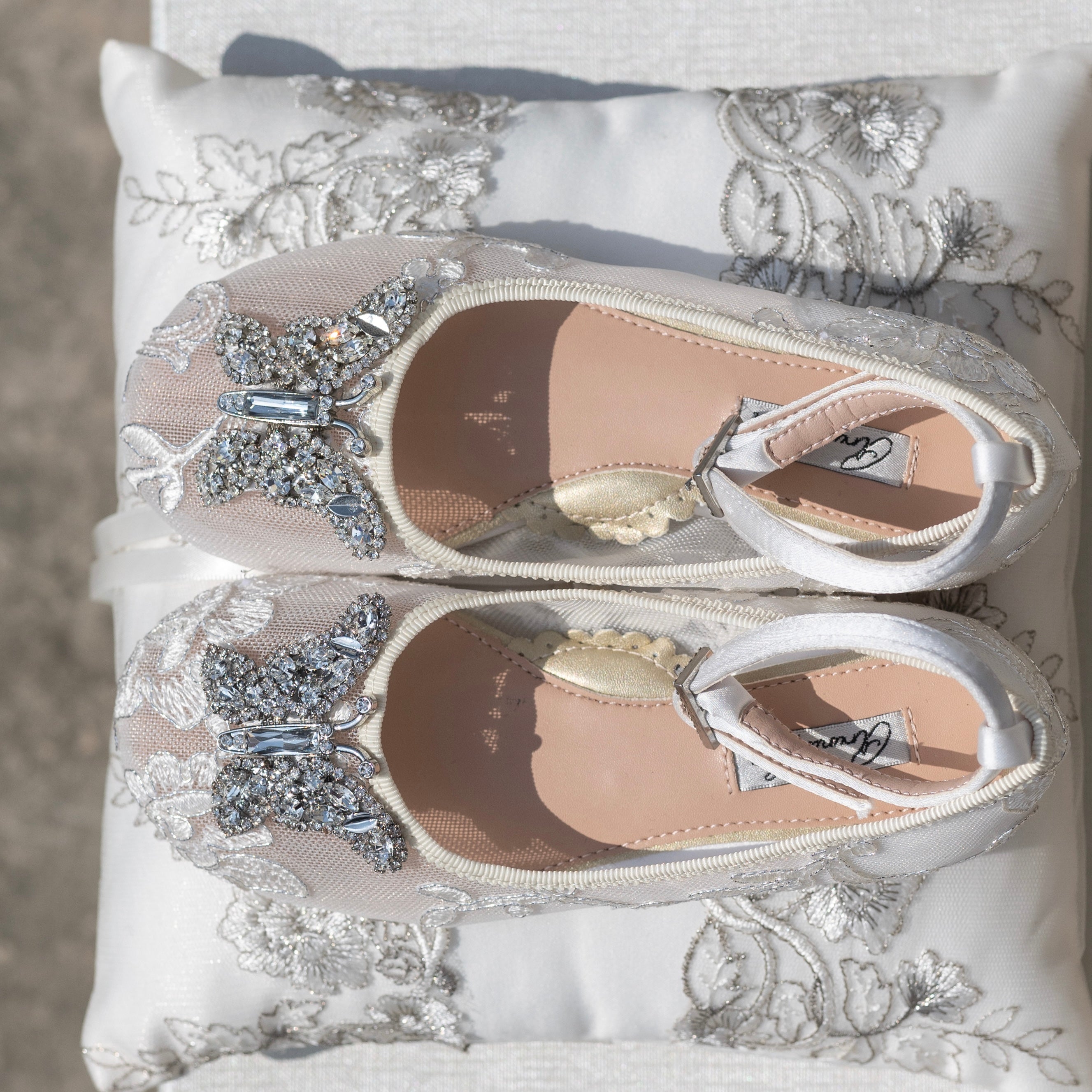 Handcrafted ivory lace flower girl shoes for luxury weddings, featuring delicate lace detailing and satin finish for elegant bridal styling.