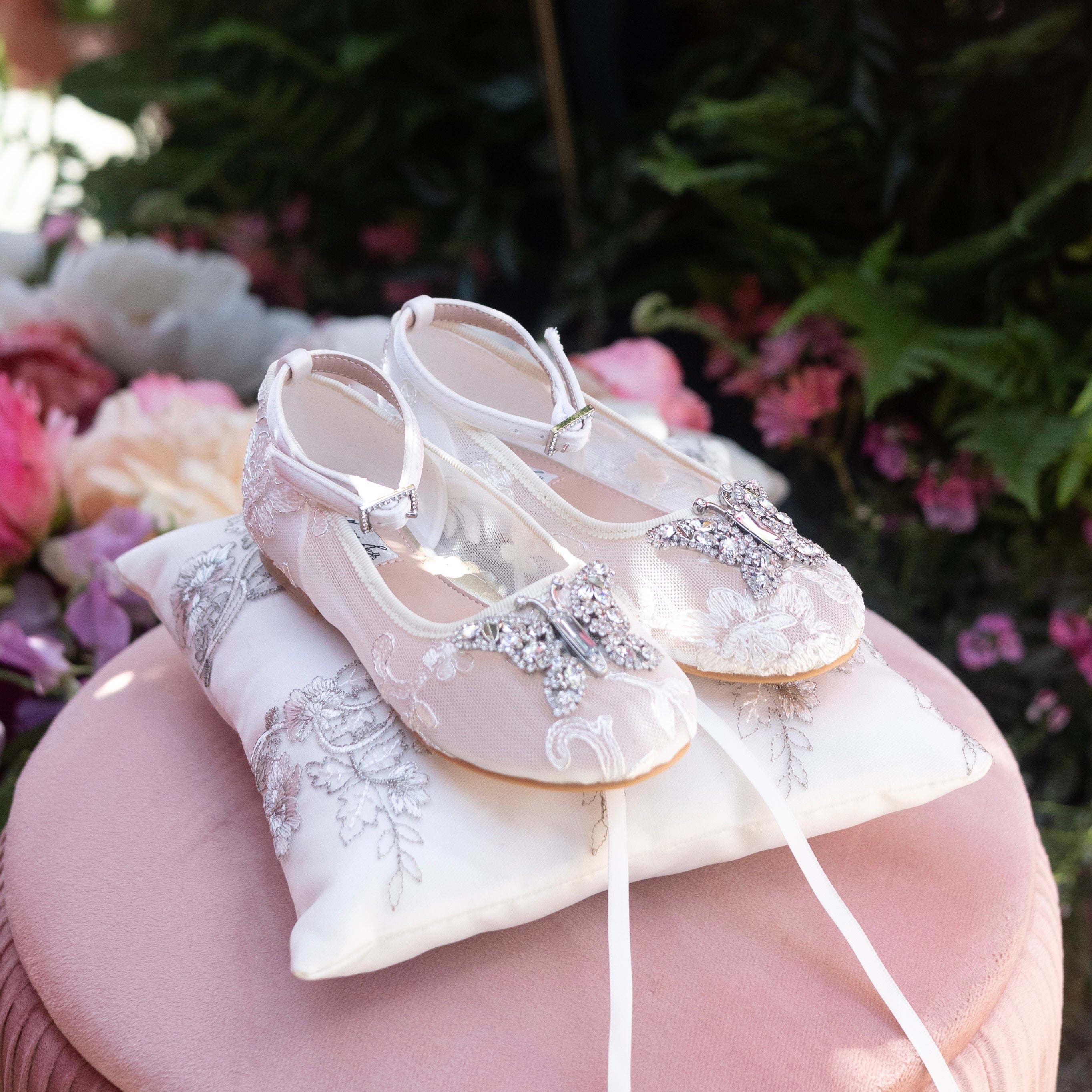 Luxury ivory Chantilly lace flower girl shoes for weddings, handcrafted with delicate lace and satin detailing for bridal ceremonies.